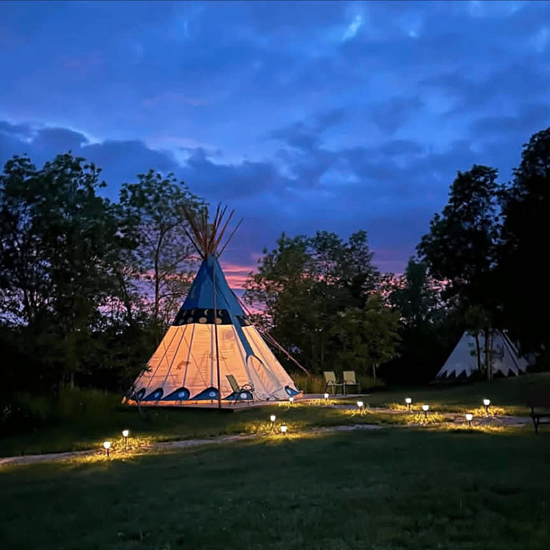 Image taken by Richard Panton of a Teepee light up a night at sunset.