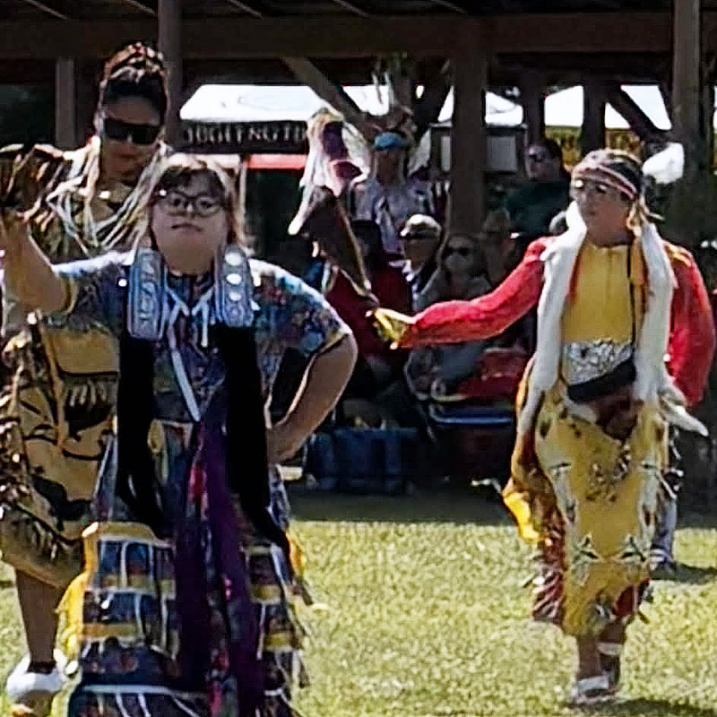 Image taken by Richard Panton of three dancers at a Pow Wow.