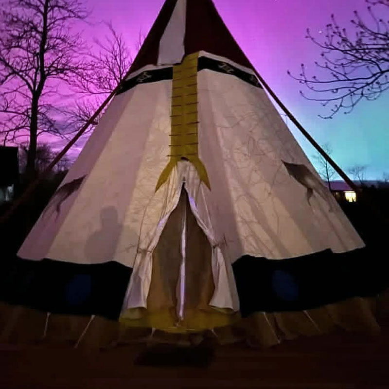 Image taken by Richard Panton of the front of a Teepee at night during a northern lights display.